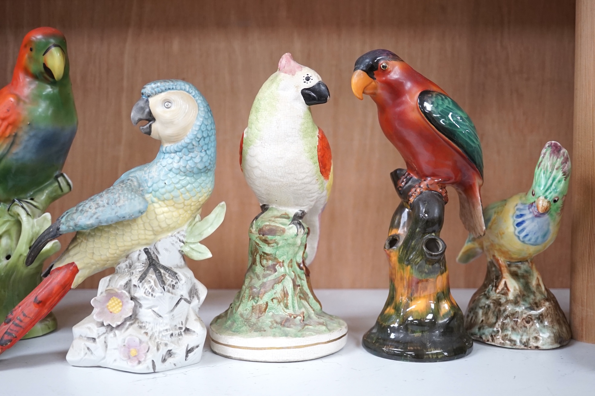 A group of twelve ceramic parrots including one by S Hancock & Sons, largest 24cm high. Condition - mostly good